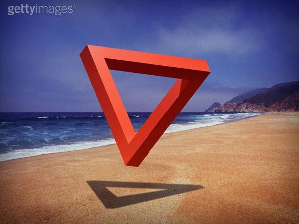 Impossible triangle floating above beach